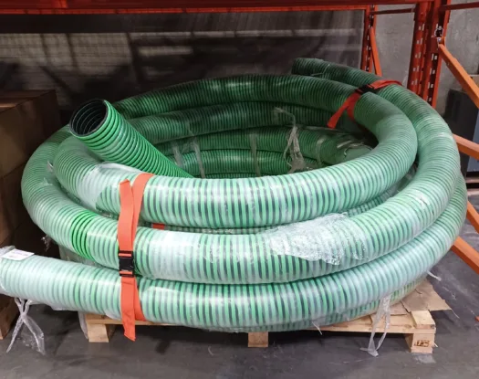 Orange bundling strap holding a coil of suction hose