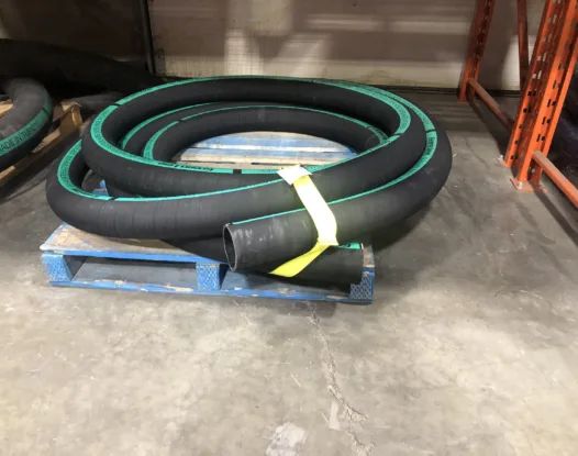 Yellow bundling strap around a coil of hose on a pallet