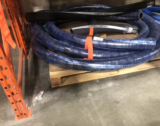 Orange bundling strap around coiled blue hose
