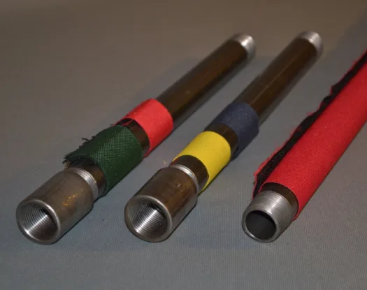 Green, yellow, blue and red markers on steel pipe