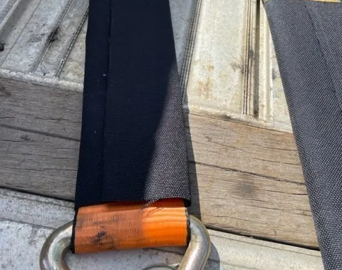 Strap saver on an orange ratchet strap