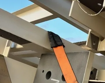 Strap saver over the edge of a steel beam