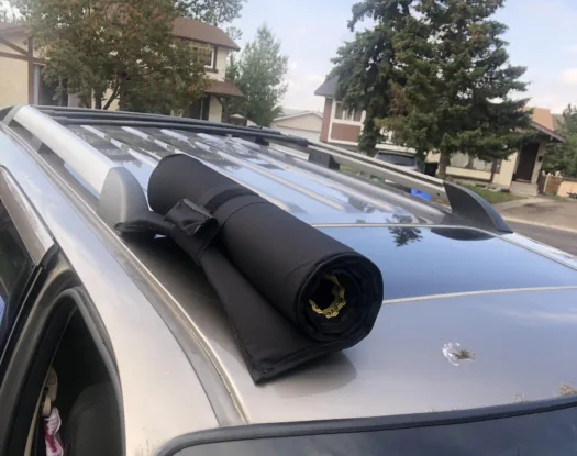 Sunroof hail cover rolled up on a roof rack