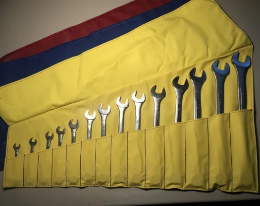 14-piece wrench holder in yellow, unrolled with wrenches