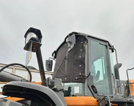 Windshield cover on a wheel loader cab
