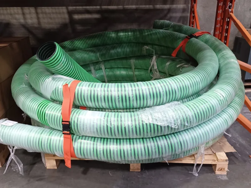 Orange bundling strap holding a coil of suction hose