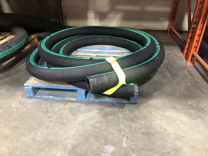 Yellow bundling strap around a coil of hose on a pallet