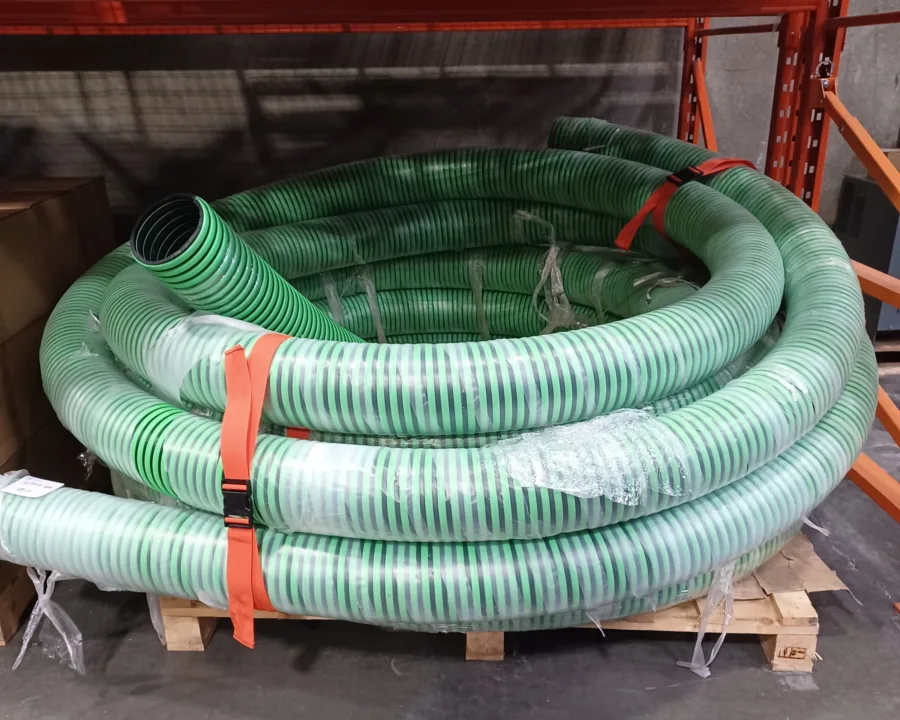 Orange bundling strap holding a coil of suction hose