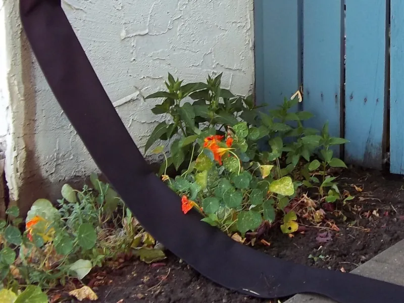 Flexible Downspout extending a downspout across a garden bed