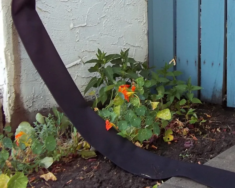Flexible Downspout extending a downspout across a garden bed