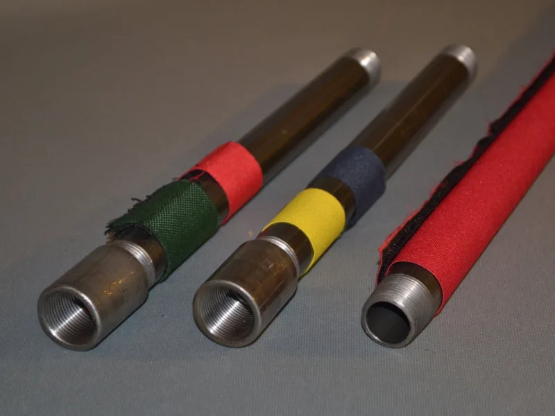 Green, yellow, blue and red markers on steel pipe