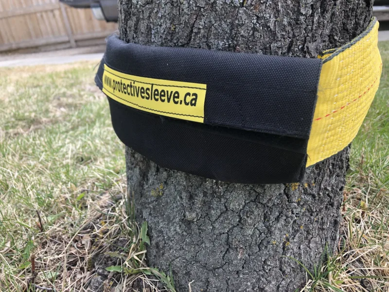 Strap saver protecting a tow strap wrapped around a tree