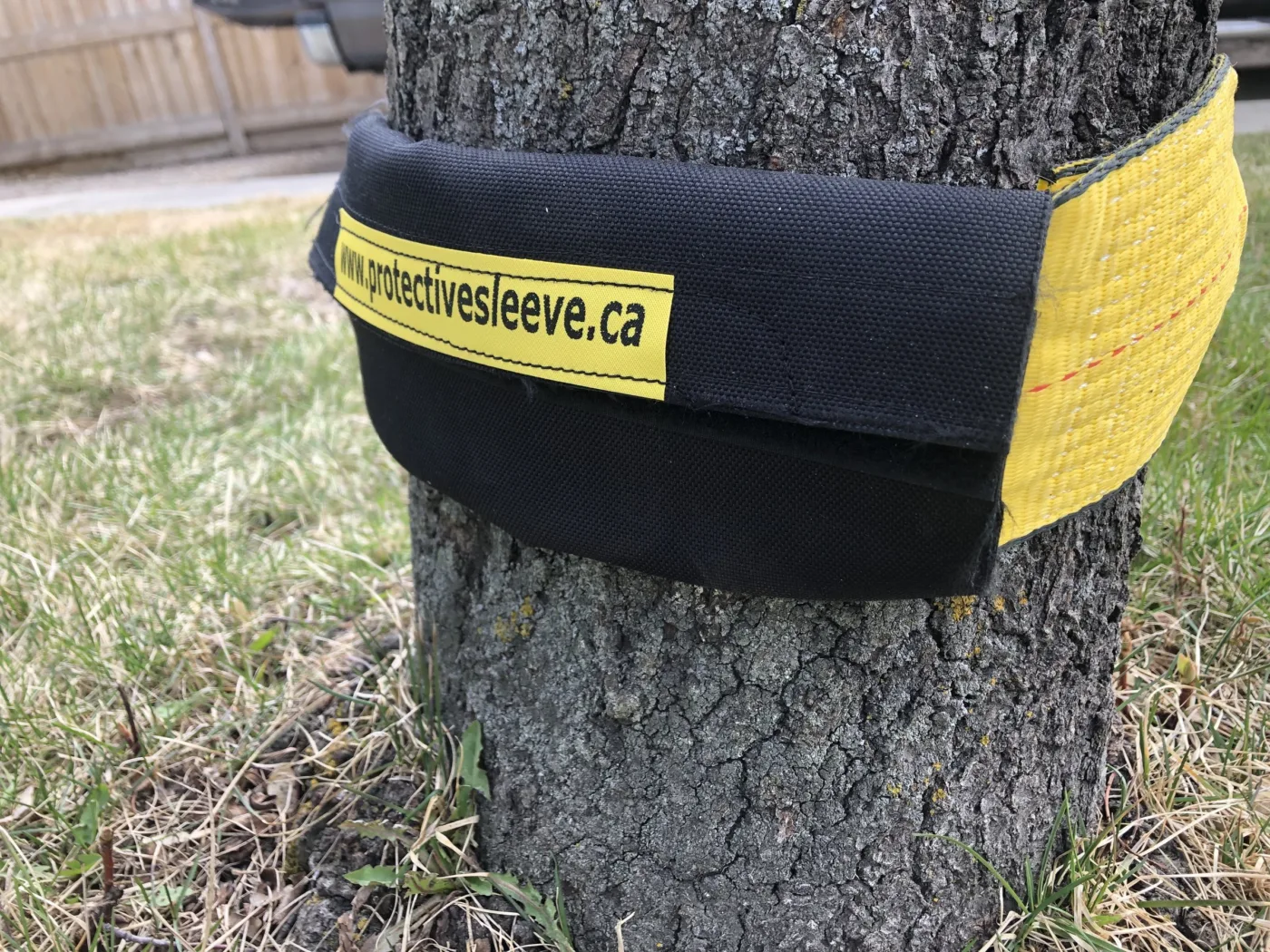 Strap saver protecting a tow strap wrapped around a tree