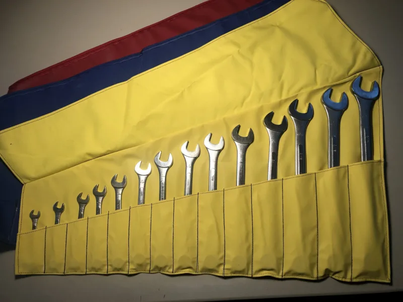 14-piece wrench holder in yellow, unrolled with wrenches
