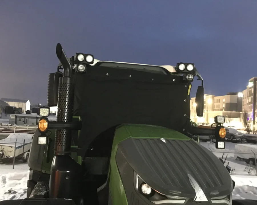 Windshield cover fitted to a tractor cab for transport